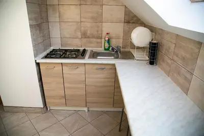 a small kitchen with a sink and a stove at Jurajska47 - trójka in Wola Kalinowska