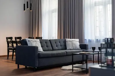 a living room with a couch and a table at Old Town Deluxe Apartment by BookingHost in Kraków