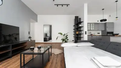 a living room with a couch and a table at Old Town Deluxe Apartment by BookingHost in Kraków