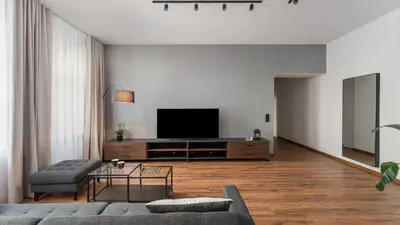 a living room with a couch and a television at Old Town Deluxe Apartment by BookingHost in Kraków