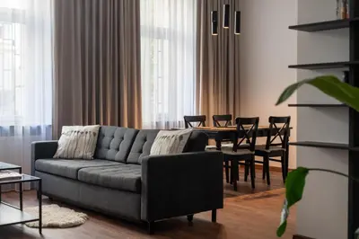 a living room with a couch and a table at Old Town Deluxe Apartment by BookingHost in Kraków
