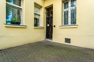 a yellow building with a door and windows at Old Town Deluxe Apartment by BookingHost in Kraków