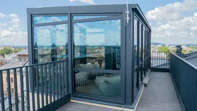 a balcony with glass doors on a building at Długa 17 Residence in Kraków