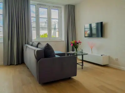 a living room with a couch and a table at Długa 17 Residence in Kraków