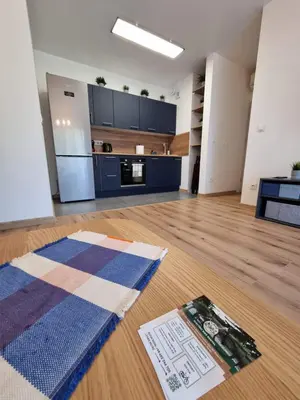 an empty room with a kitchen and a living room at Aurum Apartment in Oświęcim