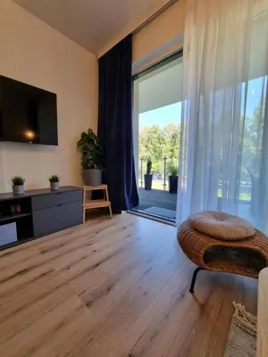 a living room with a large sliding glass door at Aurum Apartment in Oświęcim