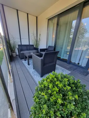 a balcony with chairs and a table on a building at Aurum Apartment in Oświęcim