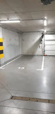 an empty parking garage with a garage door at Aurum Apartment in Oświęcim