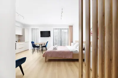 a bedroom with a bed and a table with chairs at Pychowicka 3B by Homeprime in Kraków