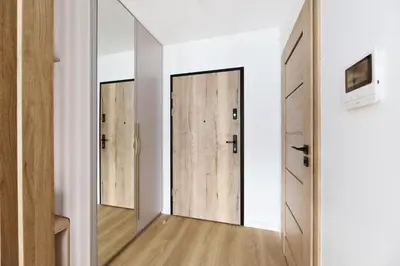 a room with three wooden doors in a room at Pychowicka 3B by Homeprime in Kraków