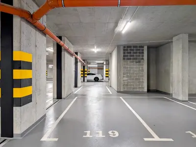 an empty parking garage with a car parked in it at Pychowicka 3B by Homeprime in Kraków