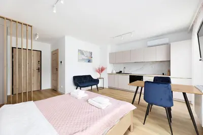 a bedroom with a bed and a table and chairs at Pychowicka 3B by Homeprime in Kraków