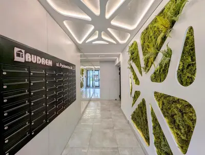 a hallway with green plants on the wall at Pychowicka 3B by Homeprime in Kraków