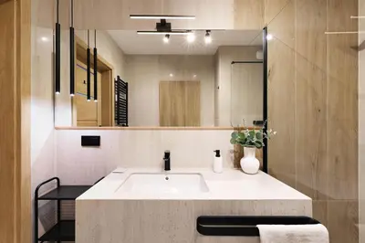a bathroom with a sink and a mirror at Pychowicka 3B by Homeprime in Kraków