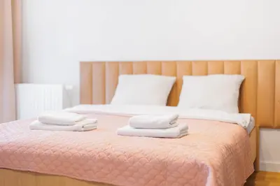 a bedroom with a bed with towels on it at Pychowicka 3B by Homeprime in Kraków