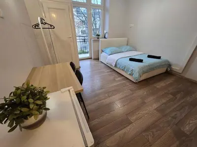 a small room with a bed and a table at Fantastic-Inn Kraków - KR63 in Kraków