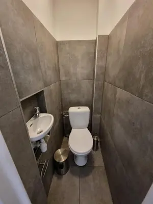 a small bathroom with a toilet and a sink at Fantastic-Inn Kraków - KR63 in Kraków