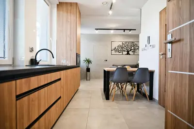 a kitchen and dining room with a table and chairs at Revel Apart in Zator