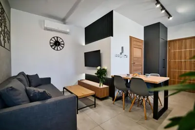 a living room with a couch and a table at Revel Apart in Zator