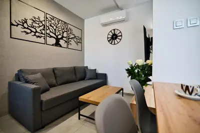 a living room with a couch and a table at Revel Apart in Zator