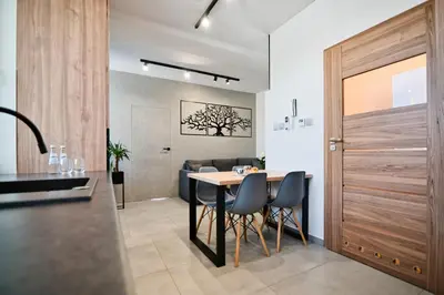 a kitchen and dining room with a table and chairs at Revel Apart in Zator
