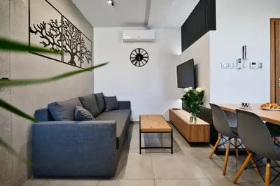 a living room with a blue couch and a table at Revel Apart in Zator