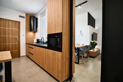 a kitchen with a microwave on a counter with a table at Revel Apart in Zator