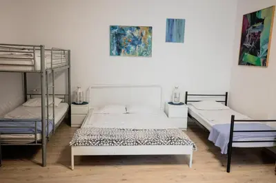 two beds in a room with two bunk beds at Funny Apartment in Kraków