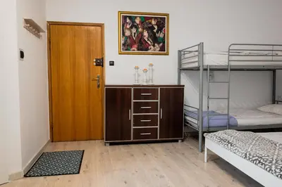 a room with two bunk beds and a wooden door at Funny Apartment in Kraków