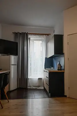 a kitchen with a sink and a window in it at Funny Apartment in Kraków