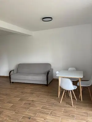 a living room with a couch and a table at Solny apartament