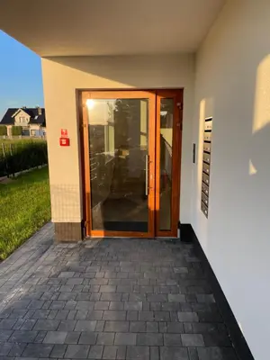 an entrance to a house with a wooden door at Solny apartament