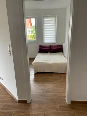 a bedroom with a bed in the middle of a room at Solny apartament