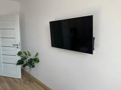 a flat screen tv hanging on a white wall at Kraków Litewska Vintage in Kraków