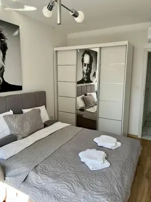 a bedroom with a bed with two towels on it at Kraków Litewska Vintage in Kraków