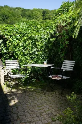 two chairs and a table and a table and two chairs at Apartamenty Pod Bocianem in Ojców