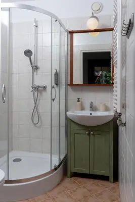 a bathroom with a shower and a sink and a shower at Apartamenty Pod Bocianem in Ojców