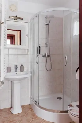 a bathroom with a shower and a sink at Apartamenty Pod Bocianem in Ojców