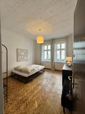a bedroom with a bed in the middle of a room at Urban rooms in Kraków