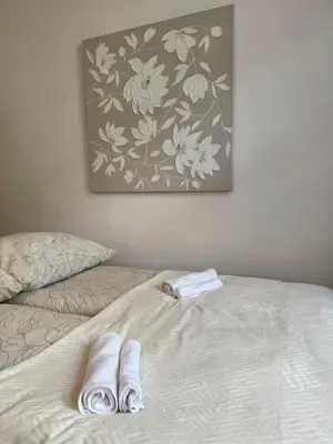 a bed with two towels sitting on top of it at Urban rooms in Kraków