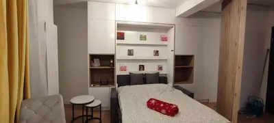 a room with a bed with a red vase on it at Wieliczka Apartment in Czarnochowice