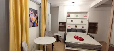 a room with a bed and a table with a red object on it at Wieliczka Apartment in Czarnochowice