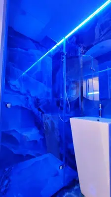 a bathroom with a glass shower with a sink at Wieliczka Lux Park in Czarnochowice