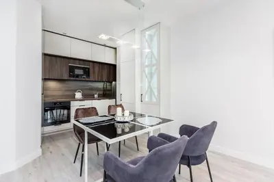 a dining room with a table and chairs at Pure Vista Apartment in Kraków