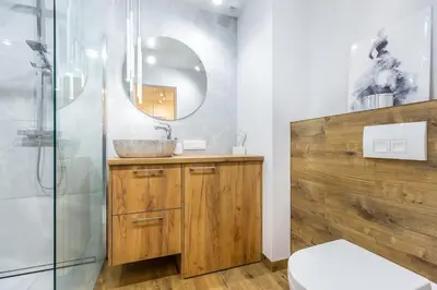 a bathroom with a sink and a mirror at Pure Vista Apartment in Kraków