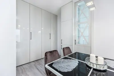 a dining room with a glass table and chairs at Pure Vista Apartment in Kraków