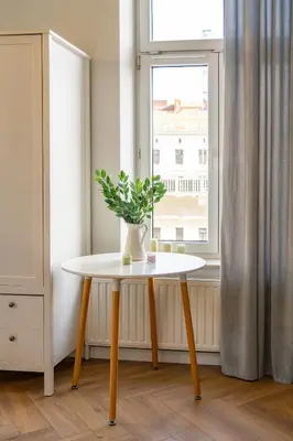 a white bed with a tray with flowers on it at Art Deco Elegance in Kraków