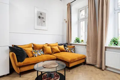 a living room with a couch and a table at Historic Hideaway - Podgórze - by Upstairs in Kraków