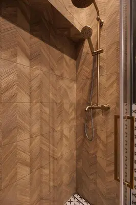 a bathroom with a shower with a wooden wall at Historic Hideaway - Podgórze - by Upstairs in Kraków