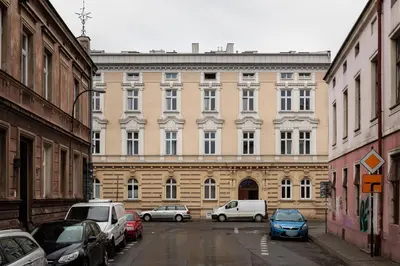 a large building with cars parked in front of it at Historic Hideaway - Podgórze - by Upstairs in Kraków